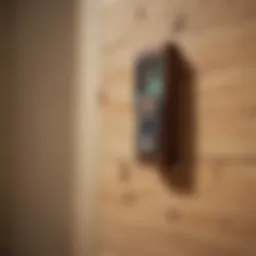 Close-up view of a wood stud finder in use on a wall.