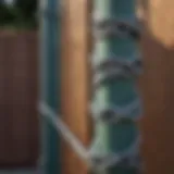 A close-up of a chain link fence post with a fresh coat of paint