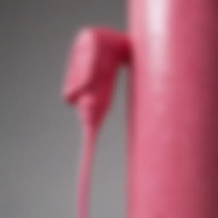 Close-up of pink spray paint application on plastic