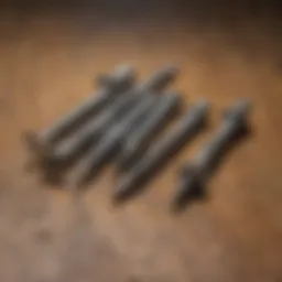 A close-up view of various types of exterior deck screws arranged on a wooden surface