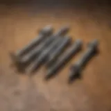 Types of Exterior Deck Screws A close-up view of various types of exterior deck screws arranged on a wooden surface