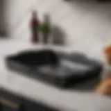 Elegant black speckled roasting pan on marble countertop