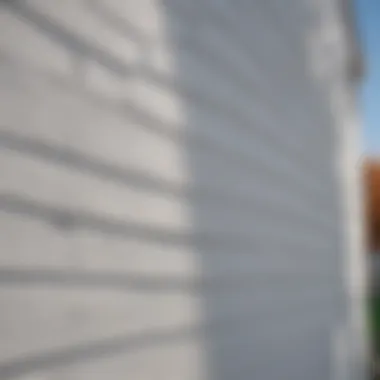 White vinyl siding installation process on a residential property