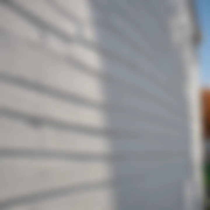 White vinyl siding installation process on a residential property