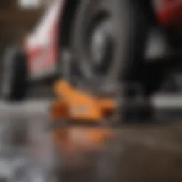 Close-up of a heavy-duty floor jack lifting a vehicle