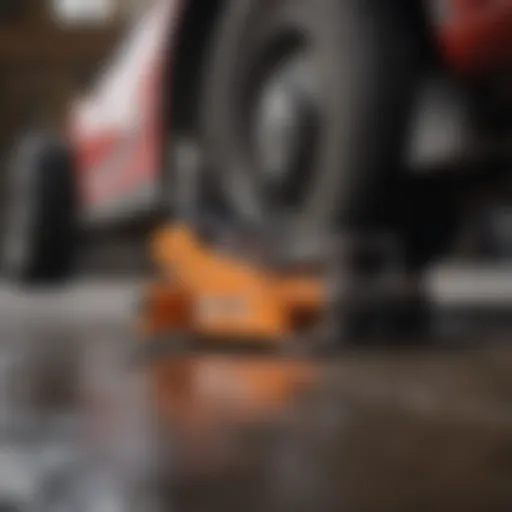 Close-up of a heavy-duty floor jack lifting a vehicle