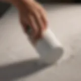 Close-up of a small foam roller applying paint on a textured surface