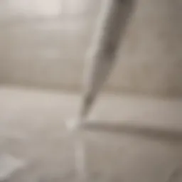 Close-up of white grout pen in action on tile