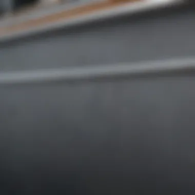 Close-up of gray paint texture on a boat's hull, highlighting its durability.