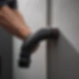Flexible rubber plumbing elbow being installed