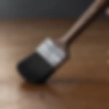 Application Techniques for Tinted Primer Close-up of a brush applying tinted Kilz oil-based primer